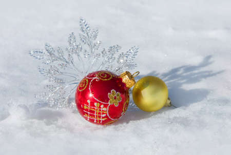 Christmas decorations on a snow background of natureの写真素材