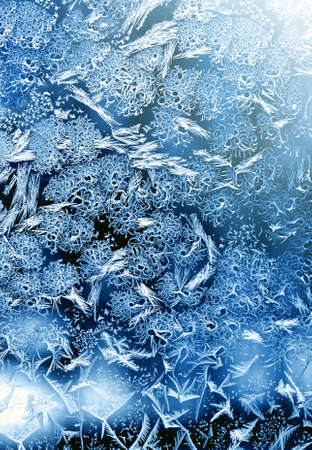Frosty christmas pattern at a winter window glass