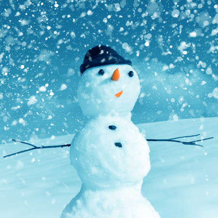 Snow man in santa cap on nature in sunny cold dayの写真素材