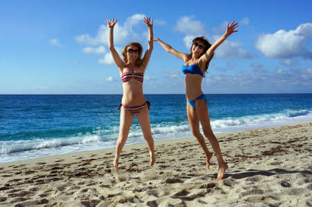  Young active women - girl friends high jump on a beach, Italy の写真素材