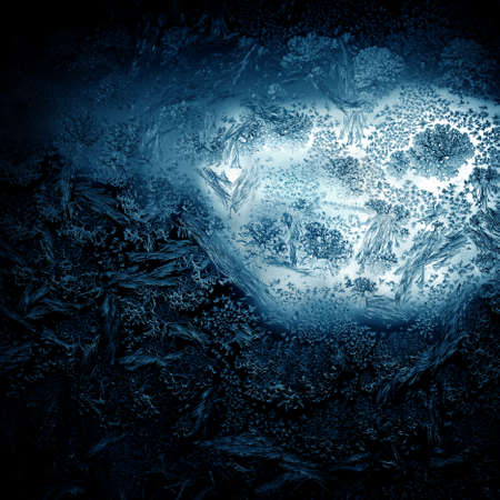 Frosty winter pattern at a window glass, macro texture
の写真素材