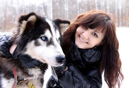 Young woman and dogs siberian husky on snow, winter  