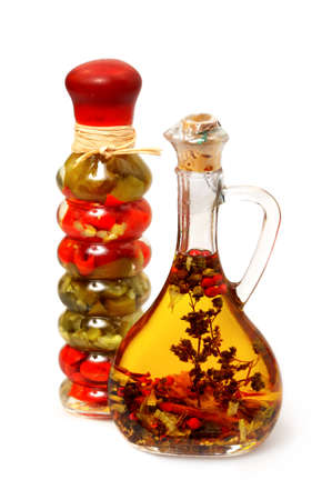 Olive oil with herbs, spices and seasonings in small bottle isolated over white backgroundの写真素材