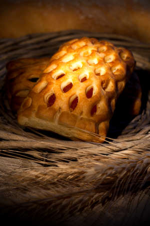 Fresh baked fruit pie with wheat on wooden table
 
