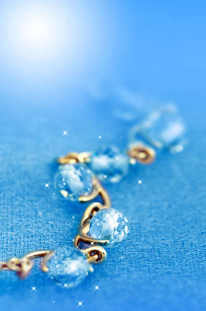 Jewelry  bracelet with blue topaz on blue backgroundの写真素材
