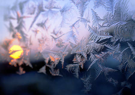 Winter frosty window glass, sunsetの写真素材