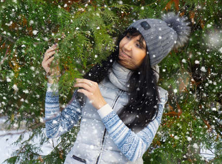 Beautiful young woman  in winter forestの写真素材