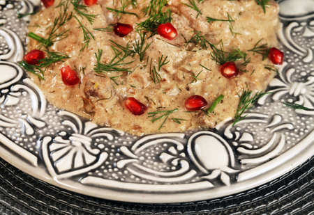 Hot a dish of ethnic cuisine of Georgia prepared from chicken meat and walnuts with pomegranateの写真素材