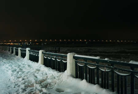 Winter nature,  night river and coast in snowの写真素材
