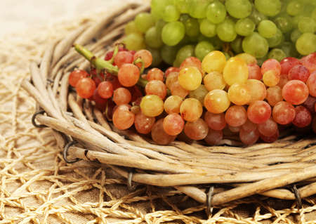 Juicy fresh red and white grapes of a fresh crop in a wattled basket