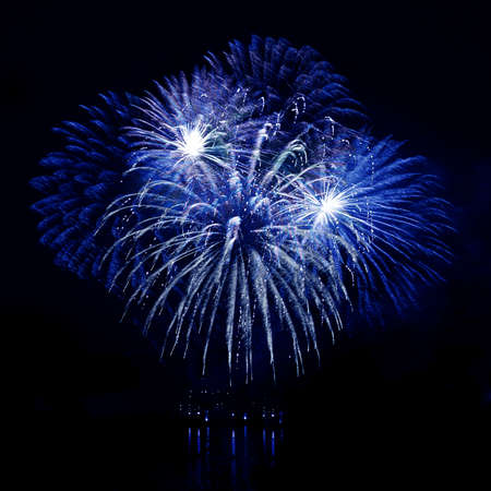 Celebratory blue firework in a night skyの写真素材