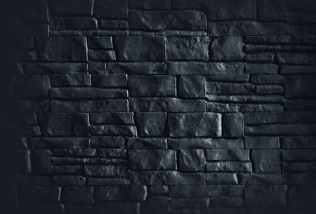 Old wall of black  bricks, a natural texture backgroundの写真素材