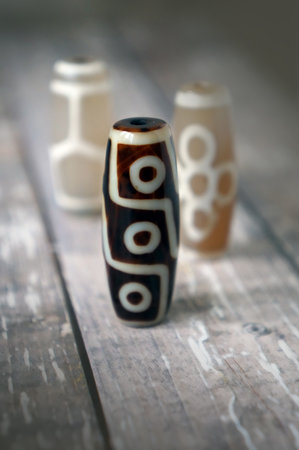 Tibetan Dzi natural beads - 9 eyes, Fortune, Turtle on wooden backgroundの写真素材