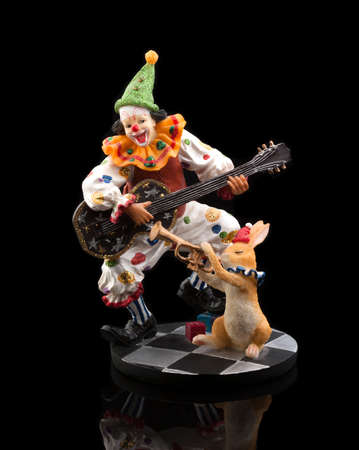 Clown in circus playing guitar for rabbitの写真素材