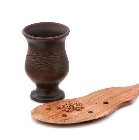 Buckwheat in a clay pot with a wooden spoonの写真素材