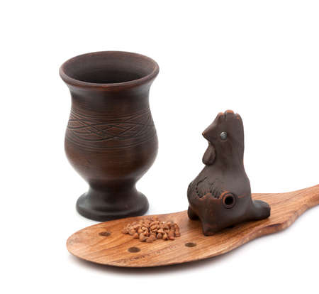 Buckwheat in a clay pot on a wooden spoon and a musical instrumentの写真素材