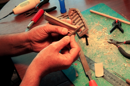 man arms making miniature boats modelsの写真素材