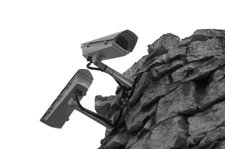Surveillance security cameras on stone wall isolated on whiteの写真素材