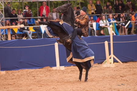 Moscow, Russia - June 22, 2013: Times and Epoch-2013 festival in Kolomenskoye park,. The Middle Ages (Srednevekove). Knight on a horse in a historical reconstruction on the joust.のeditorial素材