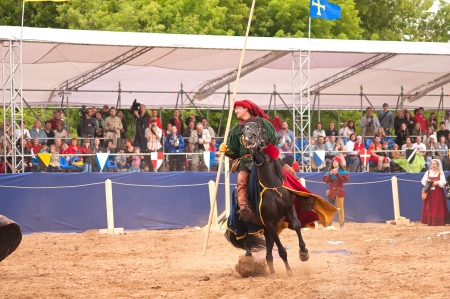 Moscow, Russia - June 22, 2013: Times and Epoch-2013 festival in Kolomenskoye park,. The Middle Ages (Srednevekove). Knight on a horse in a historical reconstruction on the joust.のeditorial素材