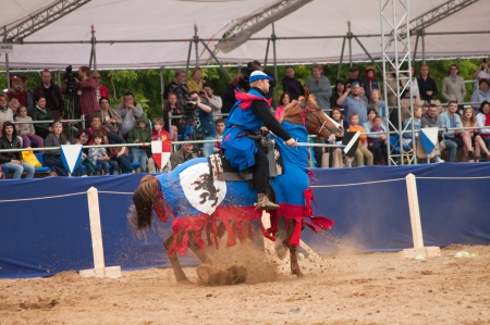 MOSCOW - JUNE 22, 2013 - Times and Epoch festival in the Kolomenskoye. The Middle Ages. - Unidentified horseman galloping on a bay stallion covered in ceremonial armor in a historical reconstruction.のeditorial素材