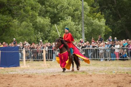 MOSCOW - JUNE 22, 2013 - Times and Epoch festival in the Kolomenskoye. The Middle Ages. - Unidentified horseman galloping on a stallion covered in ceremonial armor in a historical reconstruction.のeditorial素材