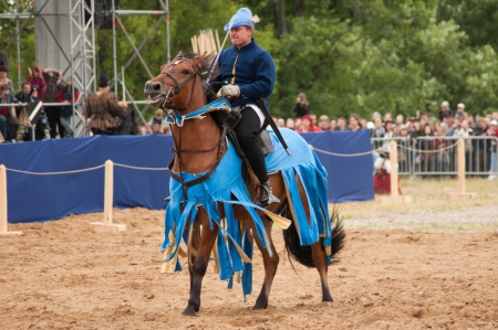 MOSCOW - JUNE 22, 2013 - Times and Epoch festival in the Kolomenskoye. The Middle Ages. - Unidentified horseman galloping on a bay stallion covered in ceremonial armor in a historical reconstruction.のeditorial素材