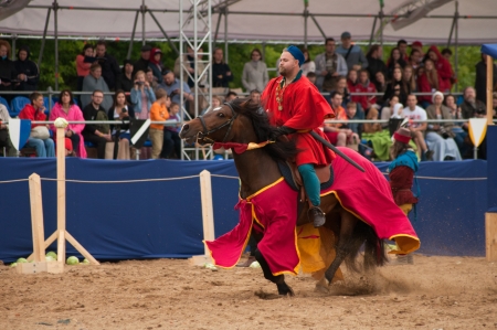 MOSCOW - JUNE 22, 2013 - Times and Epoch festival in the Kolomenskoye. The Middle Ages. - Unidentified horseman galloping on a stallion covered in ceremonial armor in a historical reconstruction.のeditorial素材