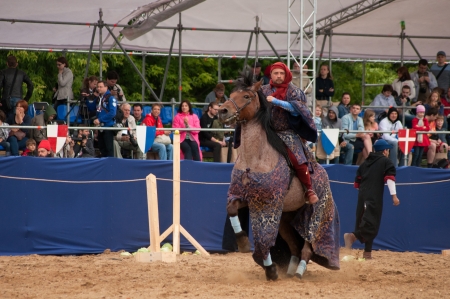 MOSCOW - JUNE 22, 2013 - Times and Epoch festival in the Kolomenskoye. The Middle Ages. - Unidentified horseman galloping on a stallion covered in ceremonial armor in a historical reconstruction.のeditorial素材