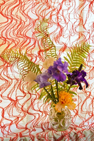 bouquet of irises on the pied blinds backgroundの写真素材
