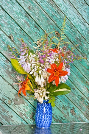 still life bouguet hosta, astilbe and hemerocallis in blue vaseの写真素材