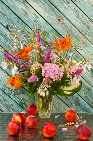 still life bouquet  hosta, astilbe, hemerocallis, pink hydrangea and nectarinesの写真素材