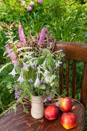 still life bouquet on the old chair with nectarinesの写真素材
