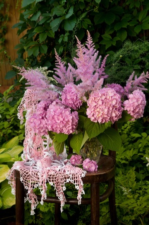 Still life bouquet with pink hydrangea and astilba on the old chairの写真素材
