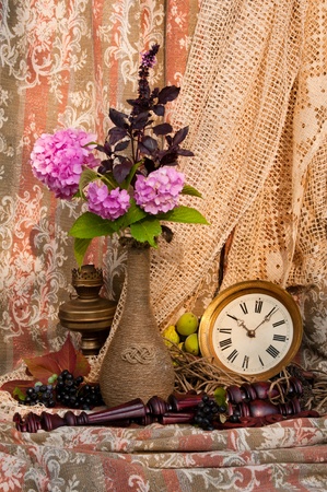 still life with antique clock and pink hydrangeaの写真素材