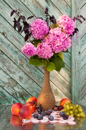 pink hydrangea and violet basil bouquet in a vintage vase still lifeの写真素材
