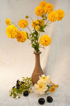 vertical still life with yellow rose and cone flowersの写真素材