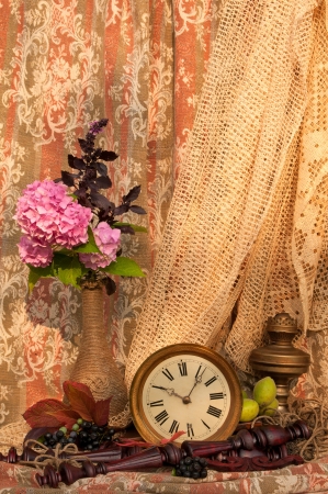still life  pink hydrangea and violet basil bouquet in the vintage vase with antique clock and oil lampの写真素材