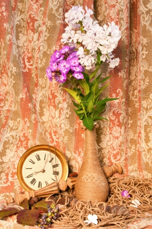 still life bouquet of phlox and antique clockの写真素材