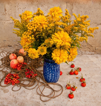 yellow flowers bouquet in the blue vase still lifeの写真素材
