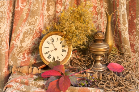 autumnal still life with clock and oil lampの写真素材