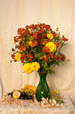 plate with fruits and bouquet of flowers still lifeの写真素材