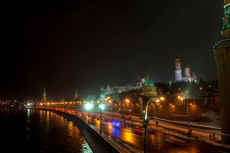 Moscow Kremlin wall and cars at the street at the snowstorm winter nightの写真素材