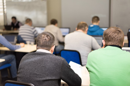 people sitting at the business conference and speaker at the screenの写真素材