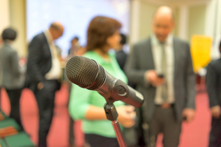 Microphone in focus against blurred audienceの写真素材