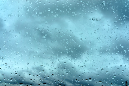 Drops of rain on blue glass backgroundの写真素材