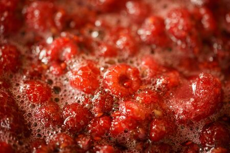 rasberry jam cooking - close up macro view of the boiling berriesの写真素材