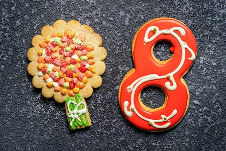 Two cookies: apple tree and number eight. Gingerbread cookies on the rustic background