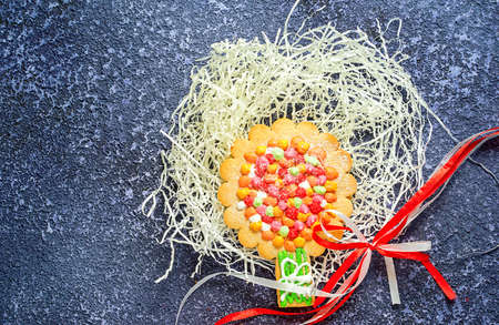 Gingerbread apple tree cookie and ribbon on wooden background with copy spaceの写真素材