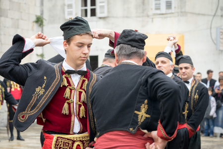 Perast, Montenegro - May 15, 2016: Shooting the Kokot (rooster) celebration. Celebrates the liberation of Perast from Turkish in 1654. Theatrical performance on a city street. Dance with hankerchief.のeditorial素材